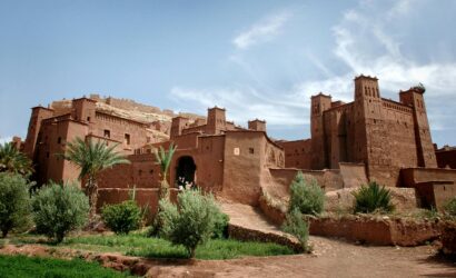 Stunning ancient clay kasbah in Ouarzazate, Morocco with clear blue sky.