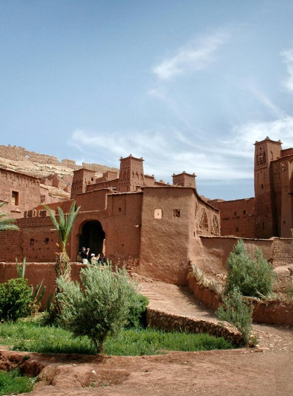 Stunning ancient clay kasbah in Ouarzazate, Morocco with clear blue sky.