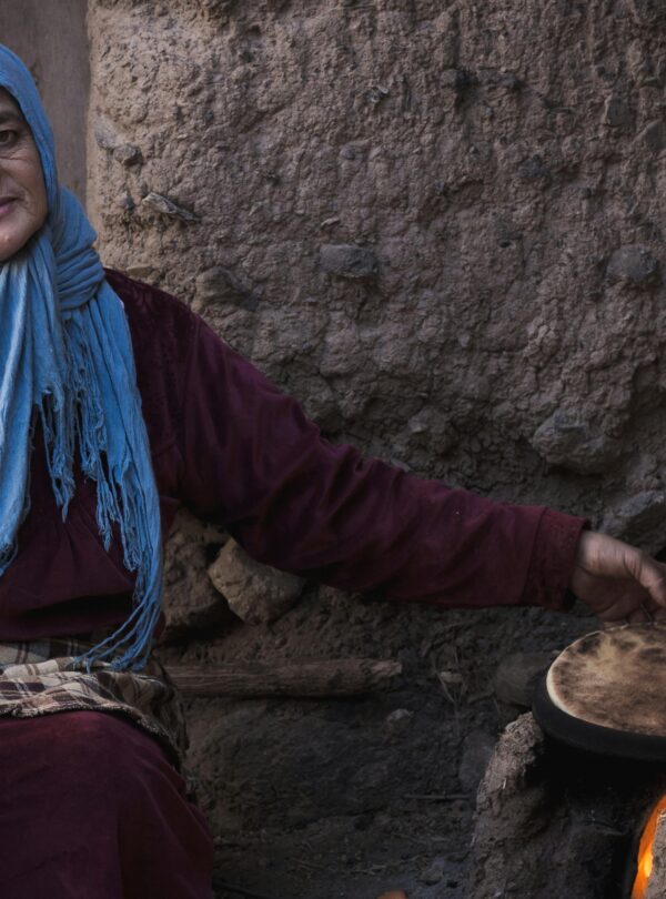 Traditional Moroccan woman baking flatbread in Ourika, Morocco.