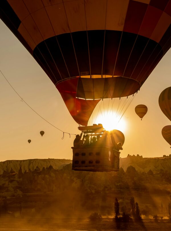 Scenic view of hot air balloons floating over Cappadocia, Turkey at sunrise.