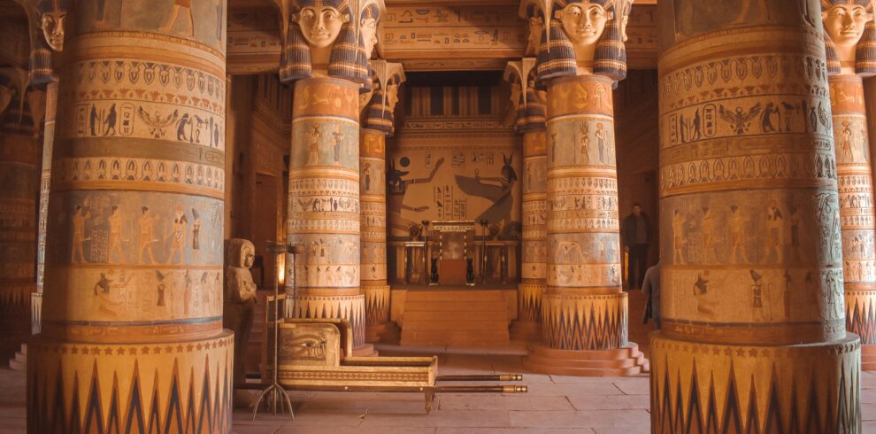 Intricate Egyptian-themed columns inside a temple-like structure in Ouarzazate, Morocco.